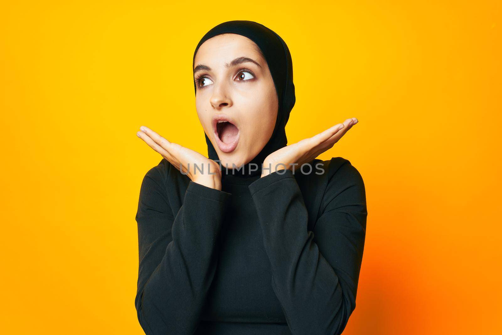 pretty woman in black hijab posing fashion hand gesture isolated background. High quality photo
