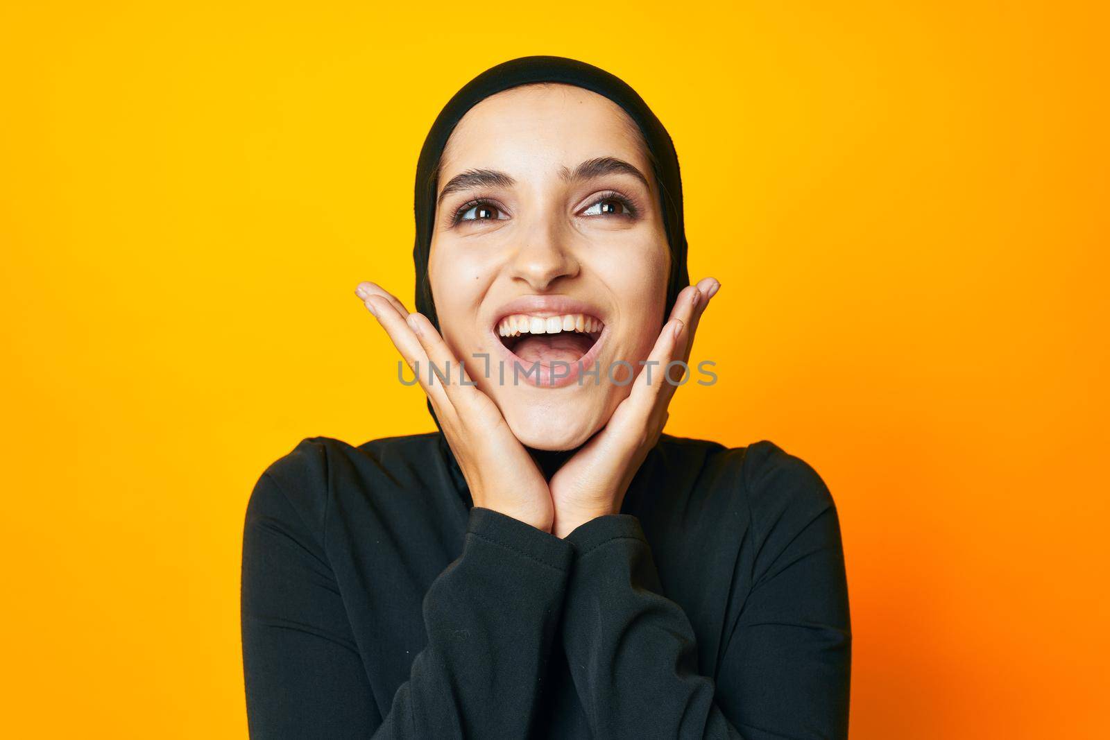 Muslim happiness fashion clothing hand gesture yellow background. High quality photo