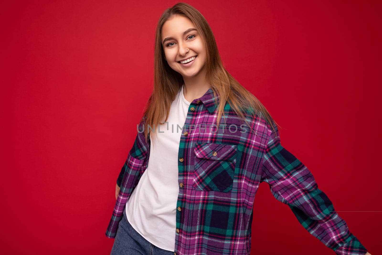 Young smling beautiful dark blonde woman isolated on background wall with copy space wearing casual white t-shirt for mockup and stylish purple shirt. Emotional concept.