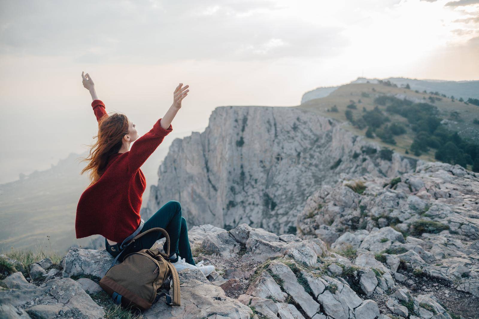 woman with backpack in mountains at altitude landscape nature. High quality photo