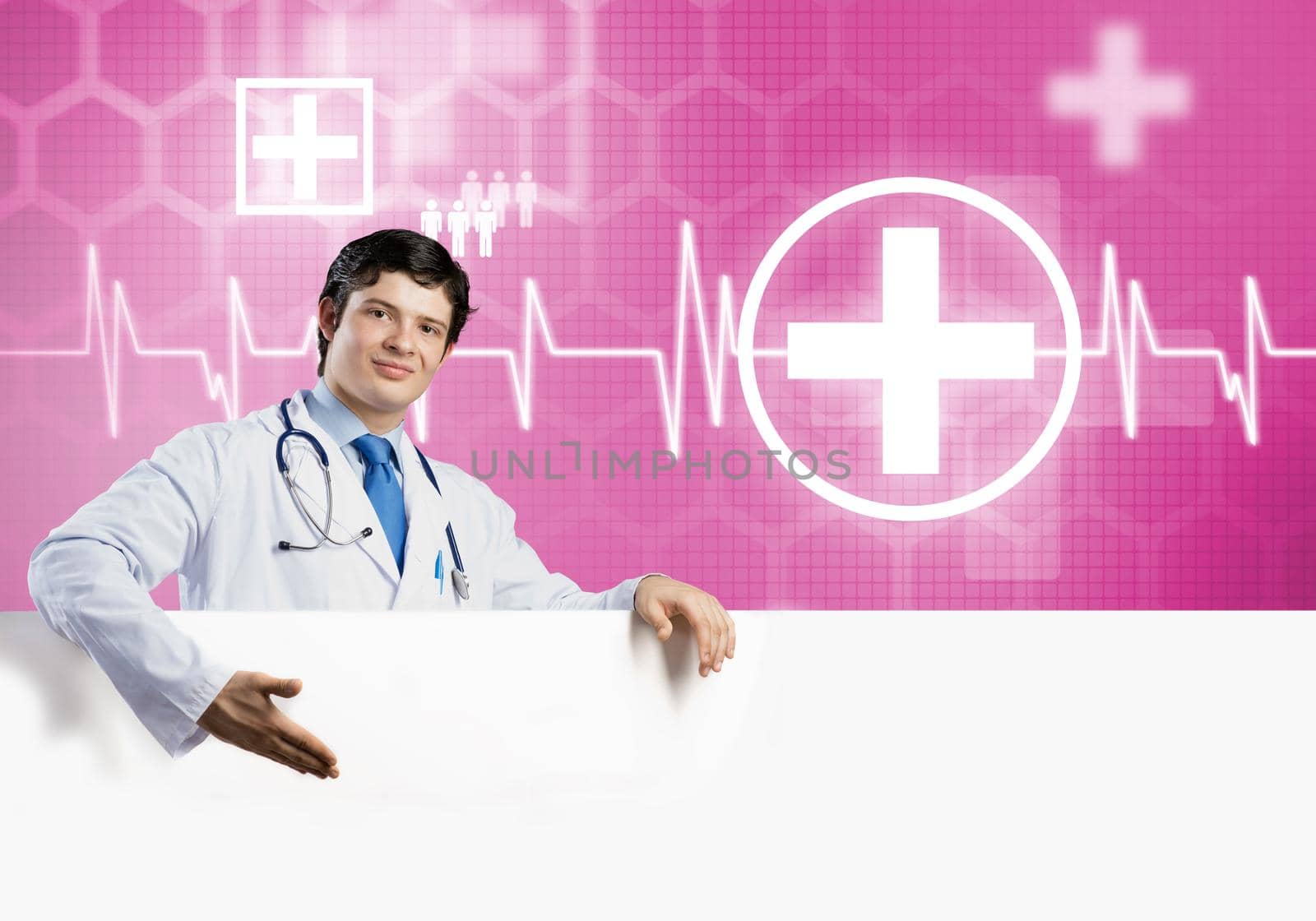 Young handsome doctor holding white blank banner. Place your text