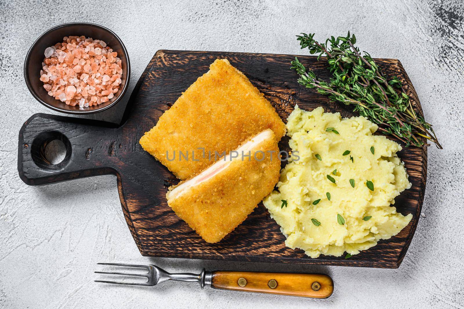 French traditional cuisine chicken fried cordon bleu meat cutlet. White background. Top view by Composter