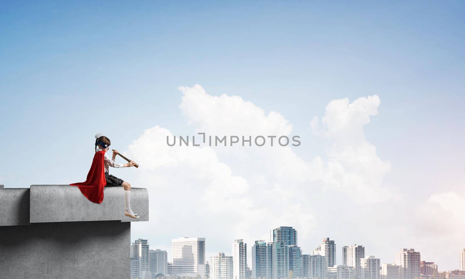 Little child in mask and cape sitting on building roof and looking in spyglass. Mixed media