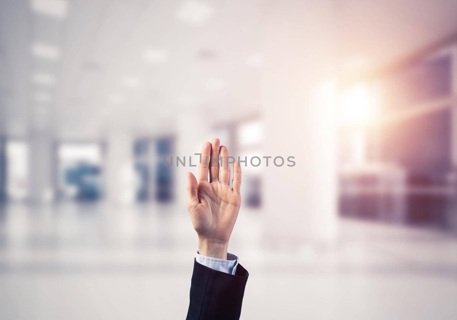 Close of businesswoman hand touching screen with palm and office at background
