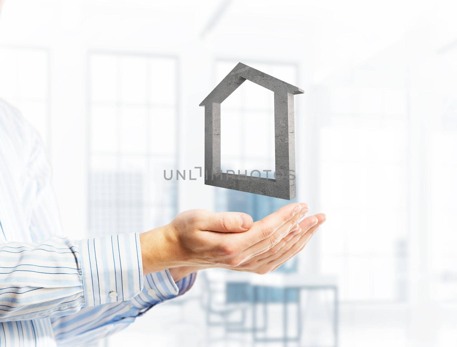 Cropped image of businessman in suit keeping stone house symbol in hands. Mixed media