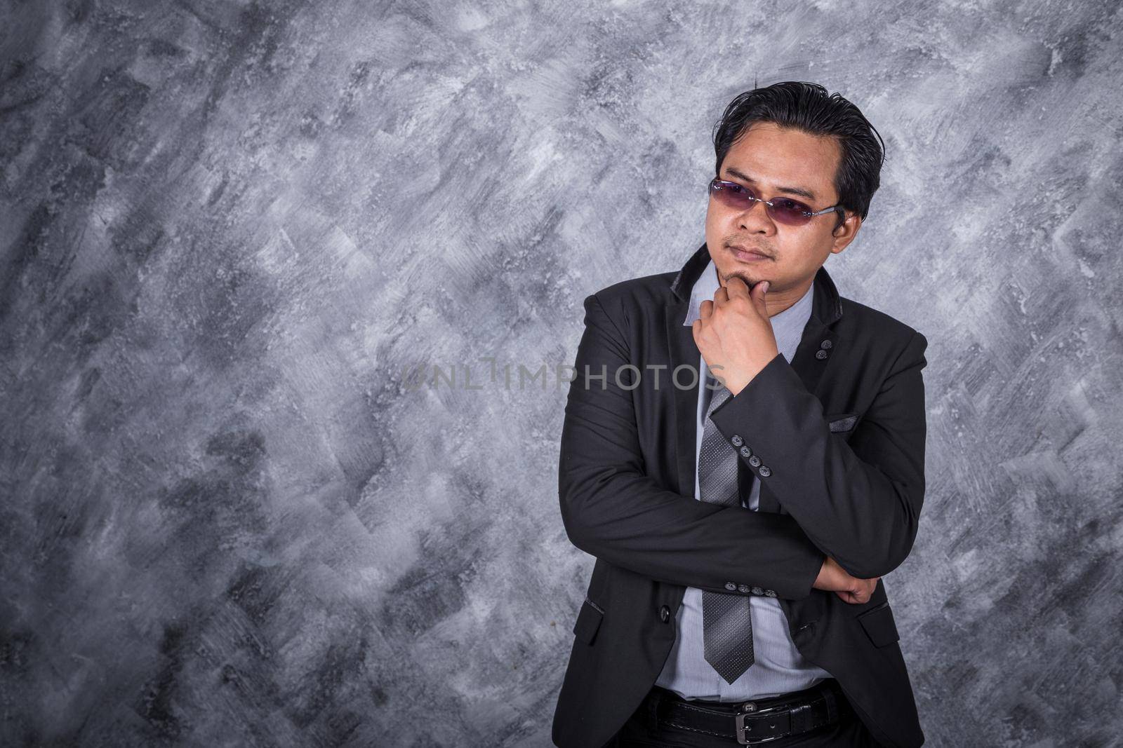 young man in suit with thinking about his business