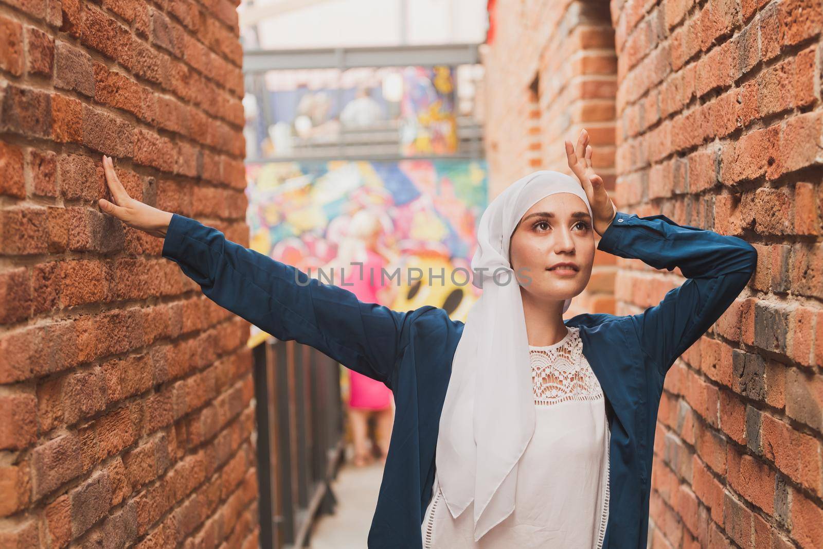 Modern muslim girl fashion with hijab.Beautiful Muslim female model wearing hijab and casual outfit posing on urban background.