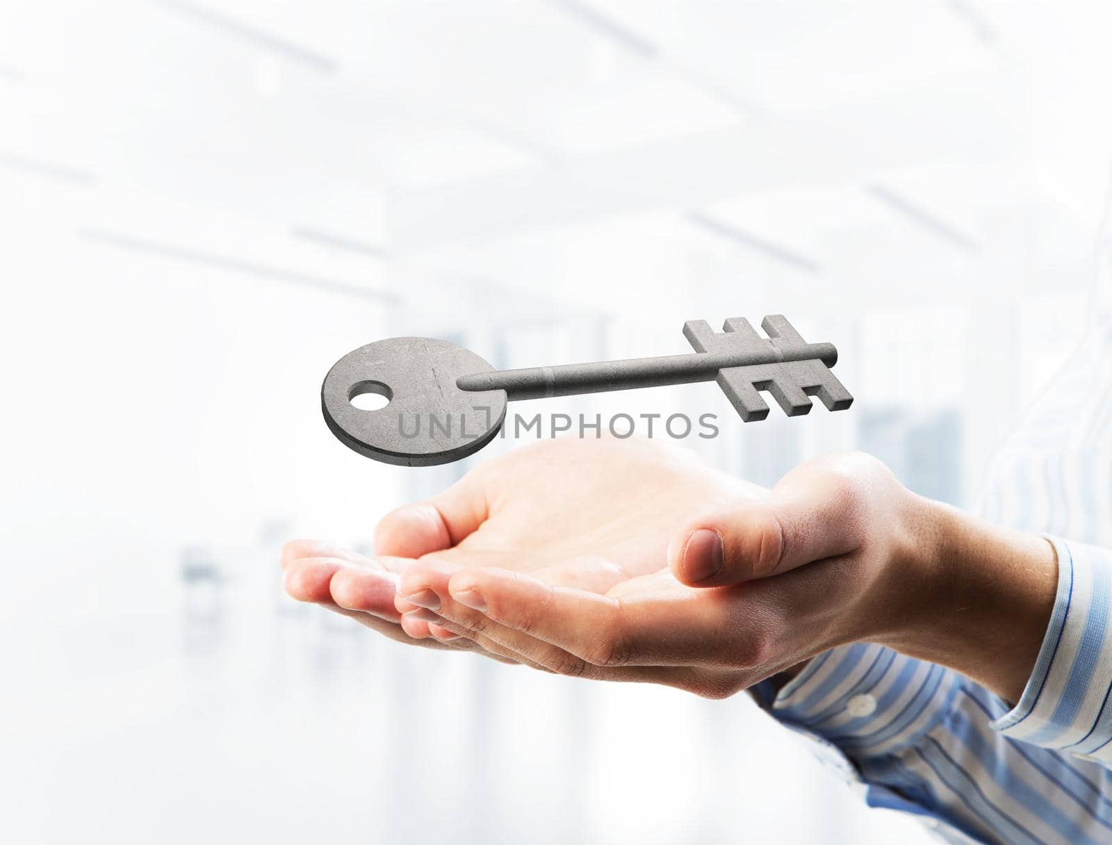 Cropped image of businessman in suit keeping stone key symbol in hands. Mixed media