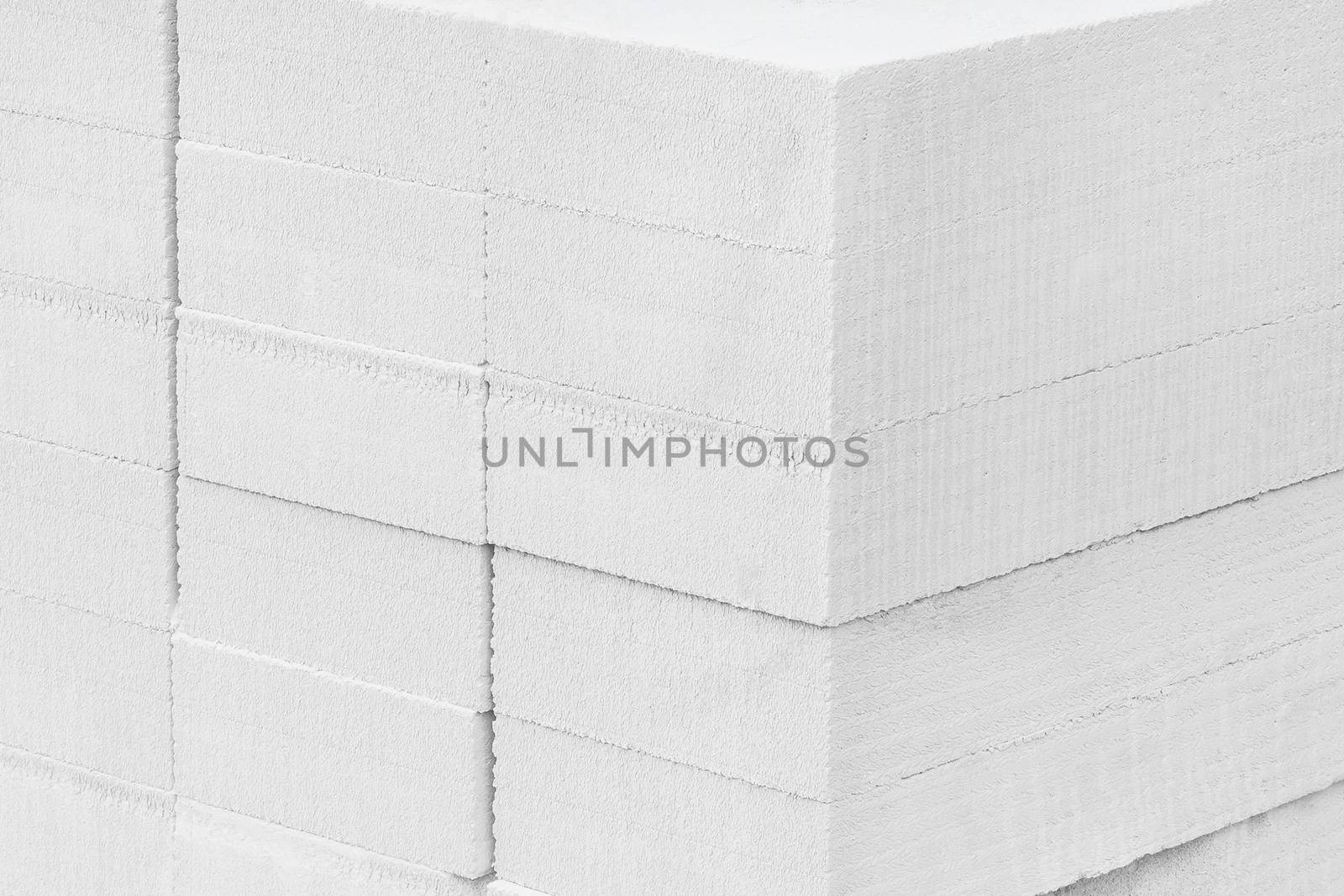 New white silicate brick blocks background. Building materials storage in warehouse at the construction site.