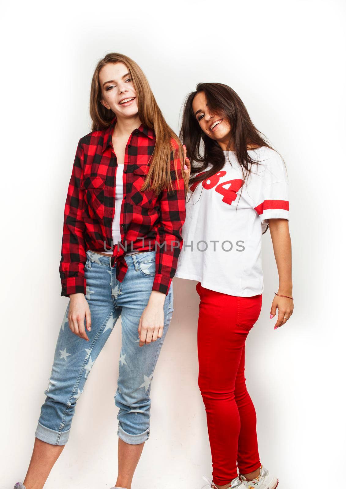 best friends teenage girls together having fun, posing emotional on white background, besties happy smiling, lifestyle people concept, blond and brunette multi nations close up