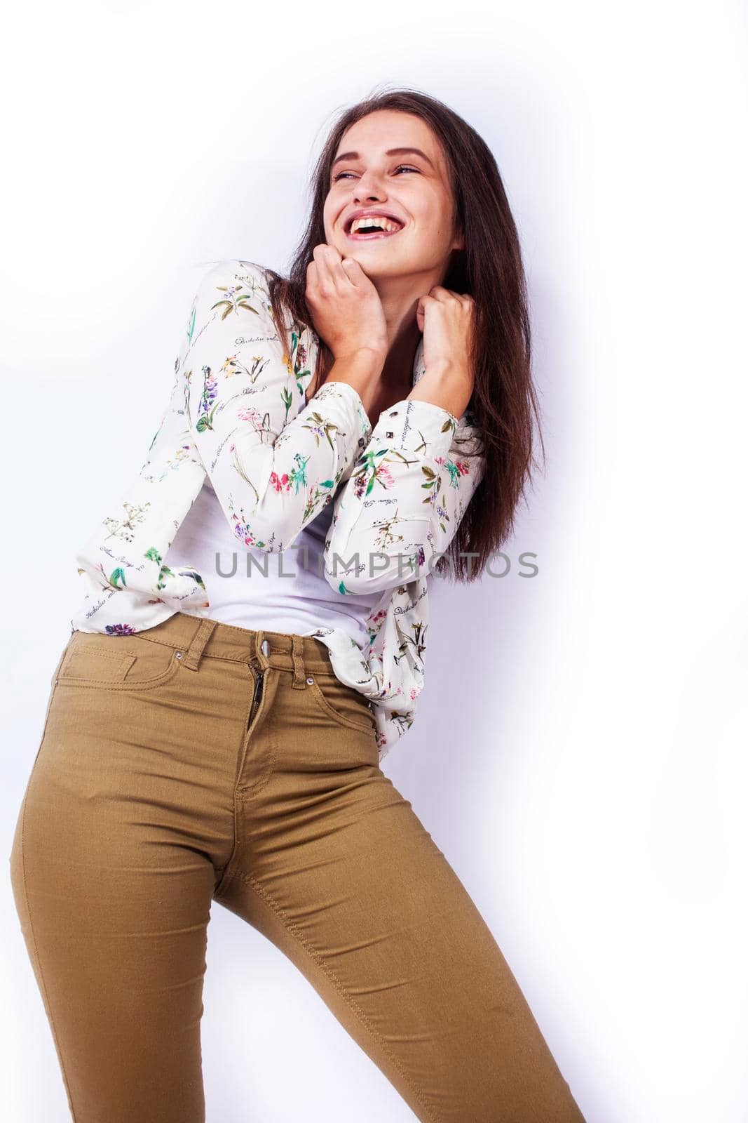 young pretty teenage hipster girl posing emotional happy smiling on white background, lifestyle people concept close up