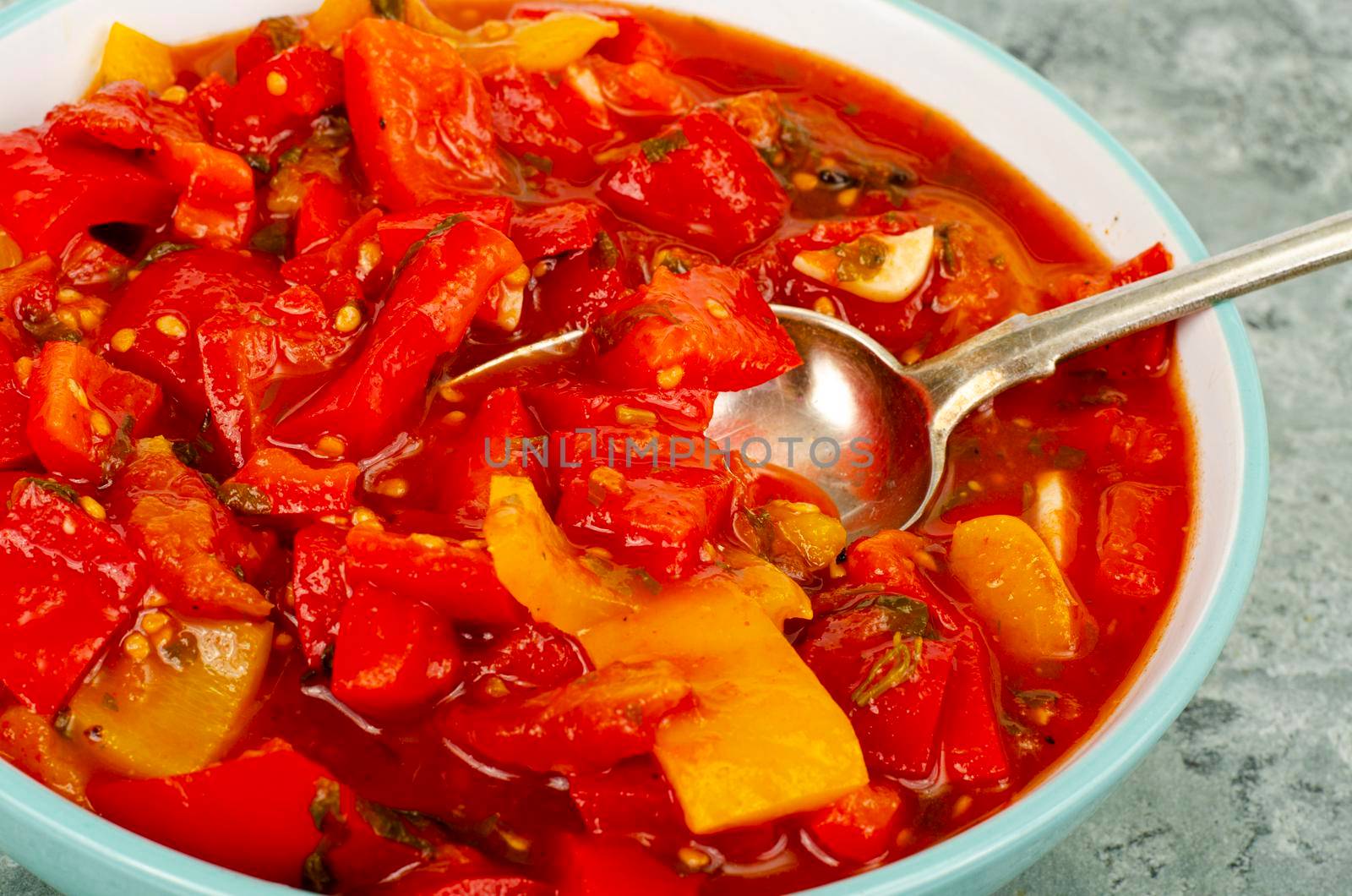 Vegetable dish of stewed sweet peppers and tomatoes, lecho, vegetarian menu. Studio Photo. by ArtCookStudio
