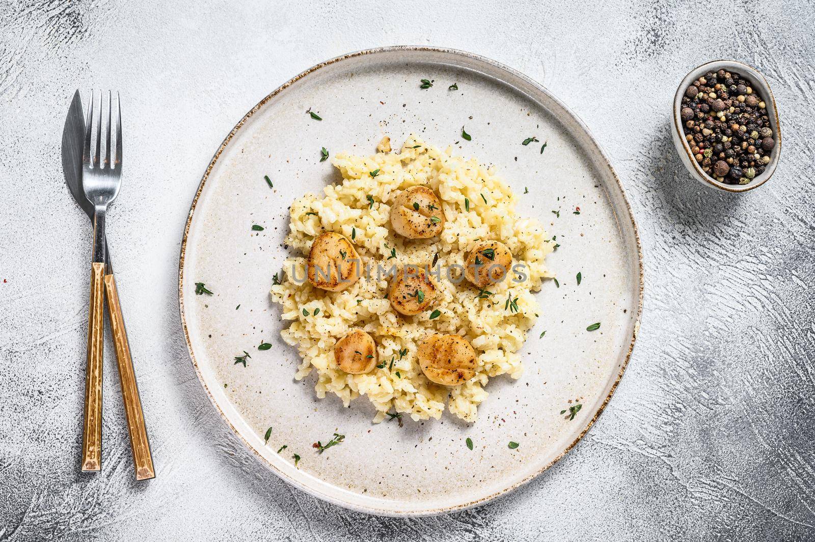 Italian Risotto with pan seared sea scallops. White background. Top view by Composter