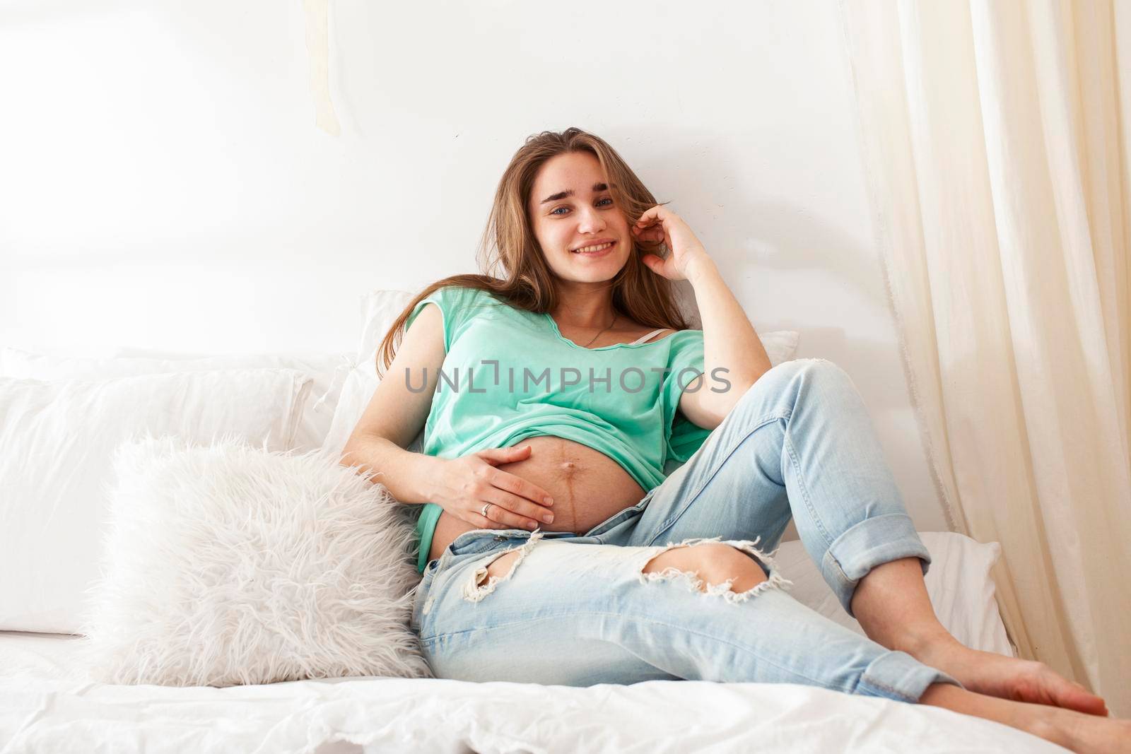 young pretty caucasian pregnant woman posing cheerful at home, lifestyle people concept close up