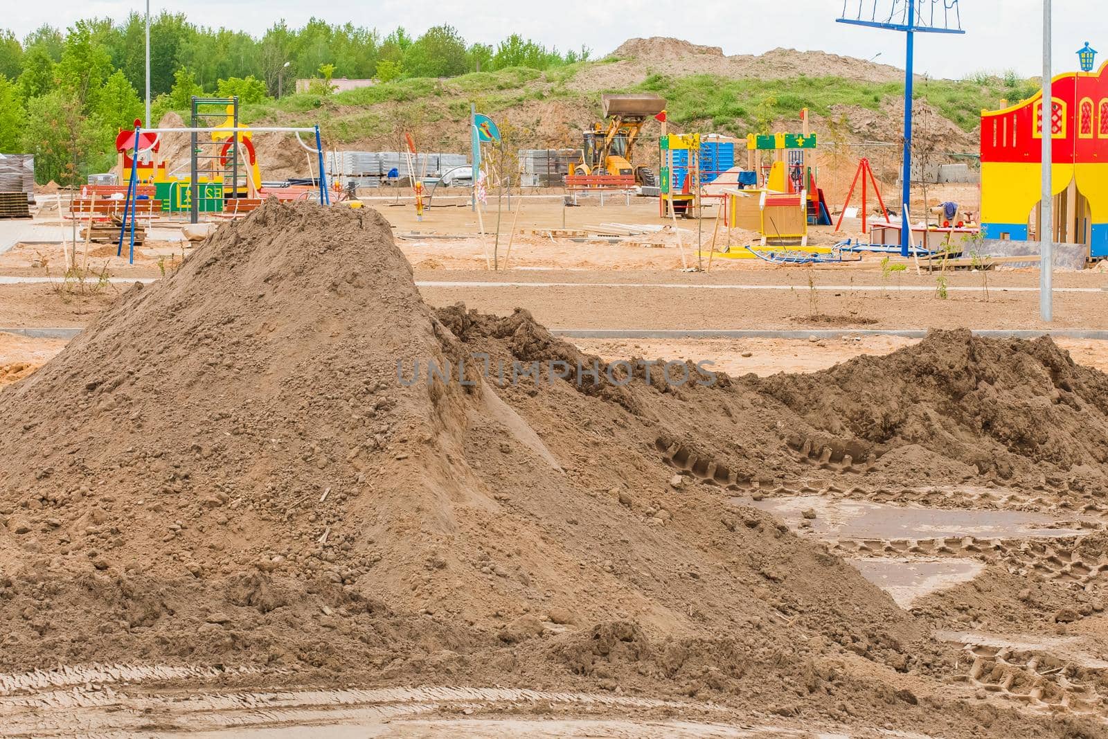 A pile of sand nature material at a construction site. Reconstruction or building a new modern playground outdoor on urban street by AYDO8