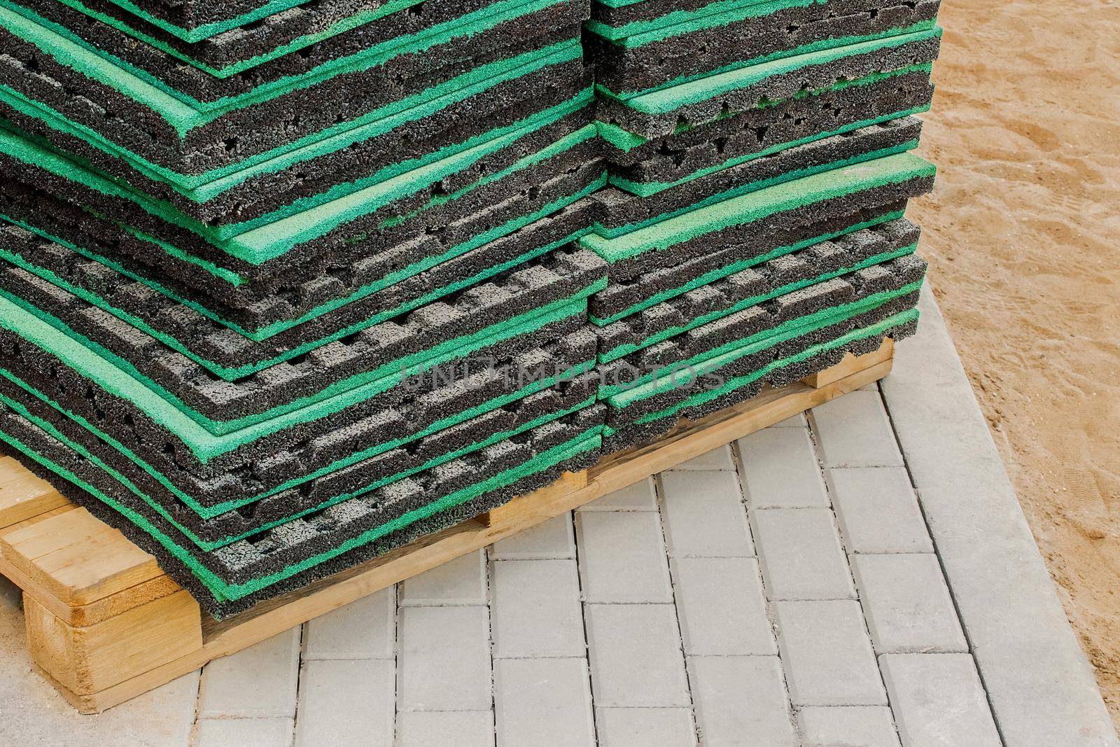 Thermal insulation or soundproof industrial building material on wooden pallet and paving slabs background, close up by AYDO8