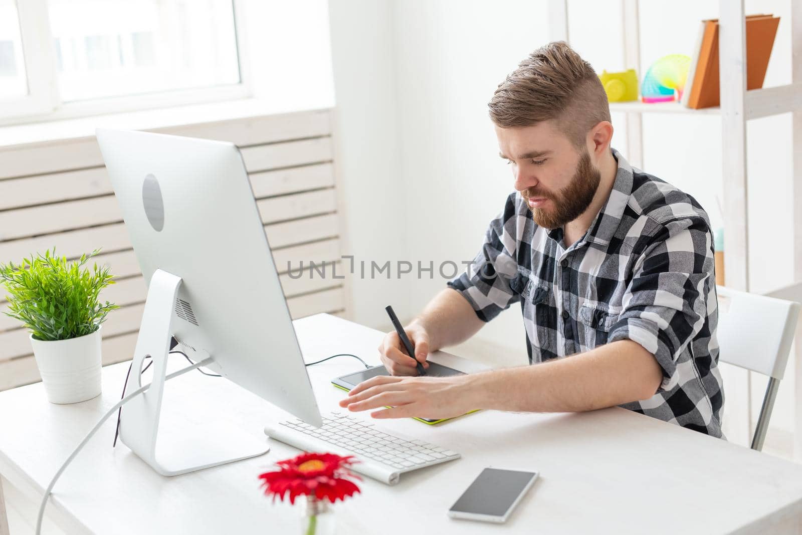 Creative, illustrator, graphic and people concept - Creative businessman writing or drawing on graphic tablet while using laptop in office