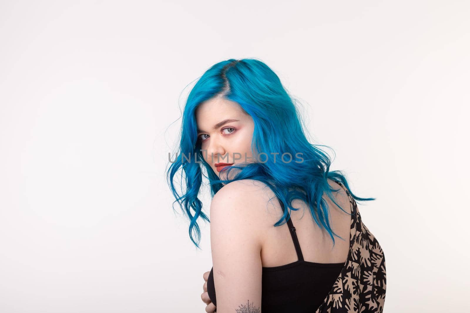 people, fashion and hair concept - beautiful girl with blue hair standing on white background.