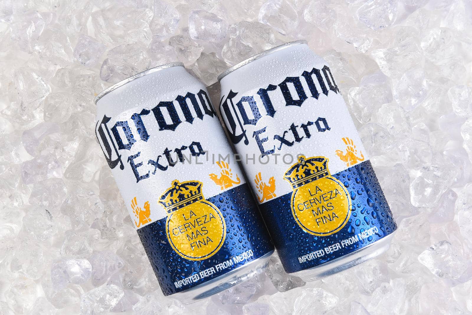 IRVINE, CALIFORNIA - MARCH 21, 2018: two 12 ounce cans of Corona Extra Cerveza on ice. Corona Extra is a pale lager produced by Cerveceria Modelo in Mexico for domestic distribution and export.