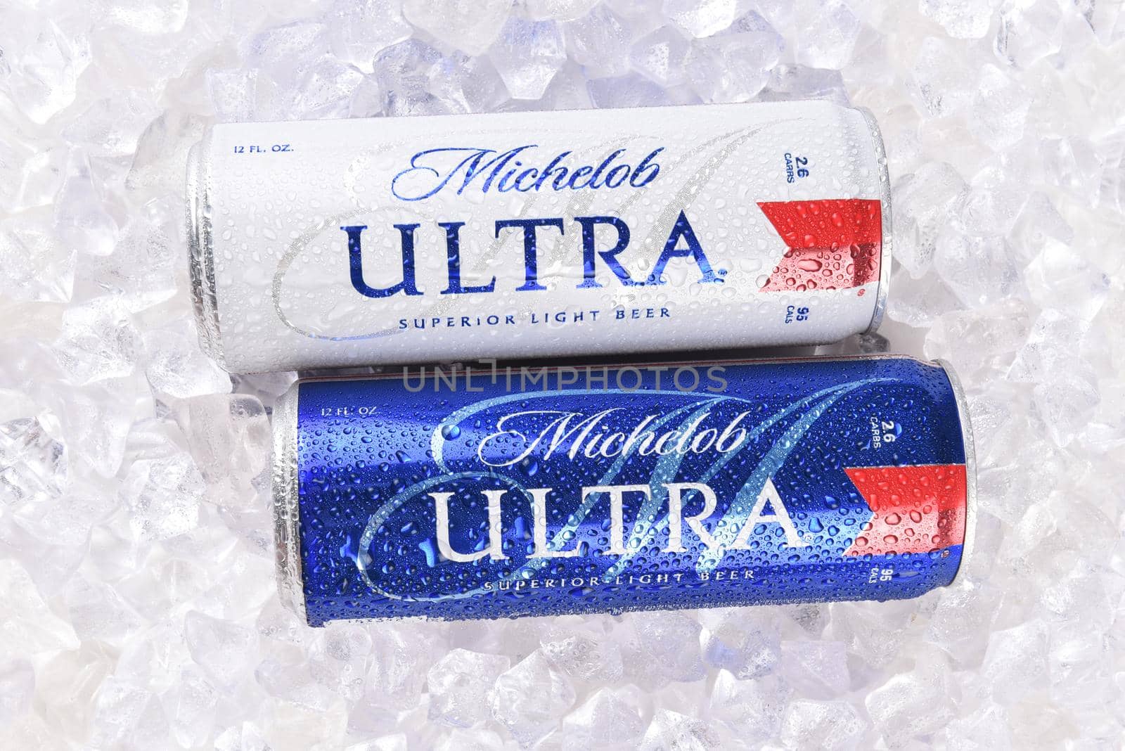 IRVINE, CA - AUGUST 6, 2018: Two Michelob Ultra beer 12 ounce cans in ice. A a low carb and low calorie light beer from Anheuser-Busch. 