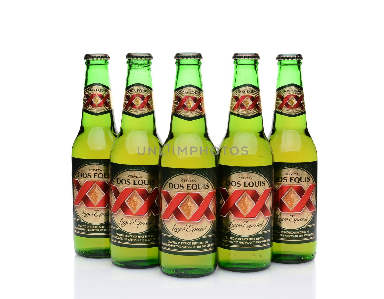 IRVINE, CA - MAY 27, 2014: Five Bottles of Dos Equis Lager Especial on white with reflection. Founded in 1890 from the Cuauhtemoc-Moctezuma Brewery in Monterrey, Mexico a subsidiary of Heineken International.