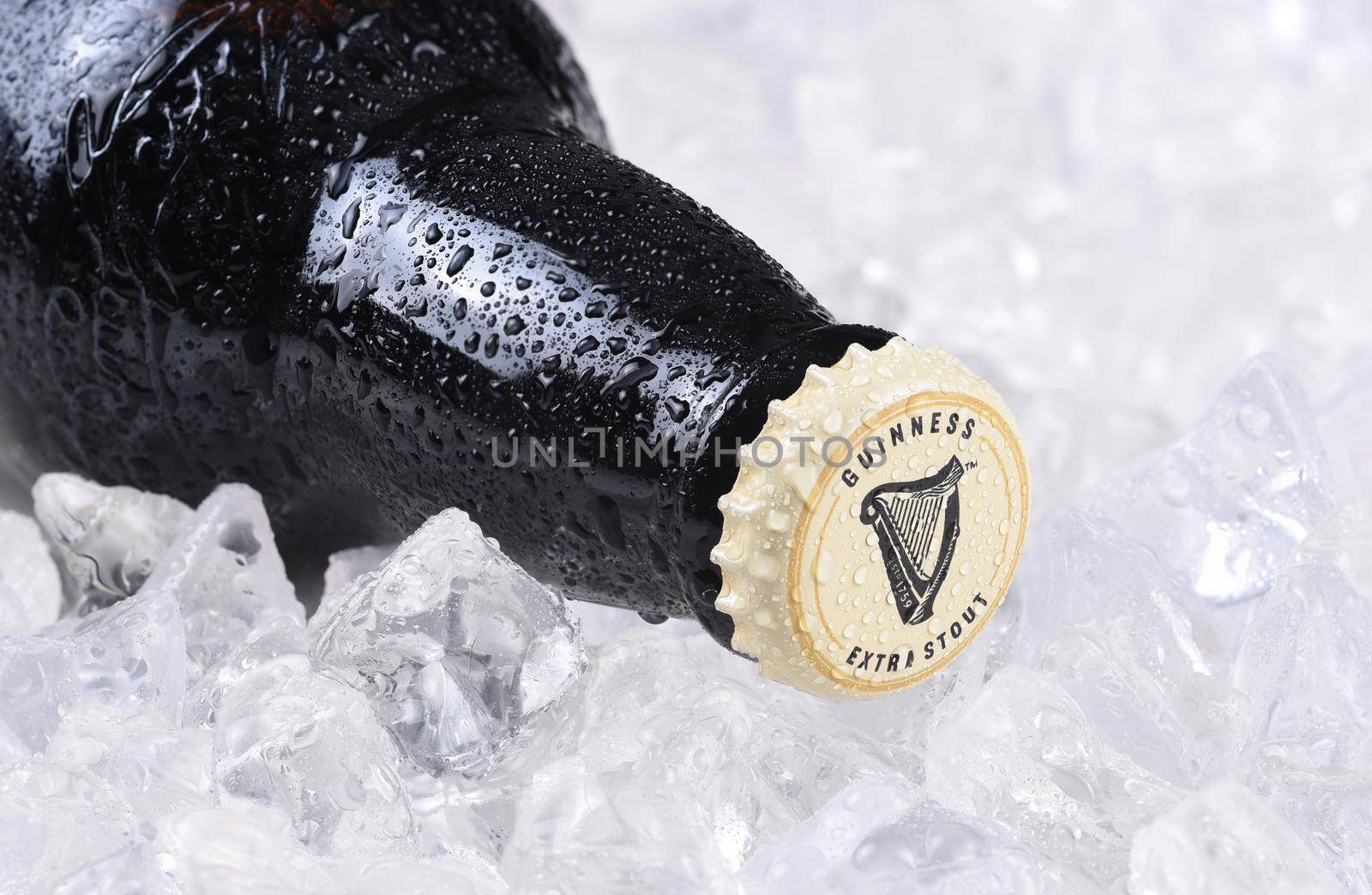IRVINE, CA - December 15, 2017: A bottle of Guinness Extra Stout on a bed of ice. The Irish beer is one of the worlds most successful beer brands with annual sales over 850 million liters.