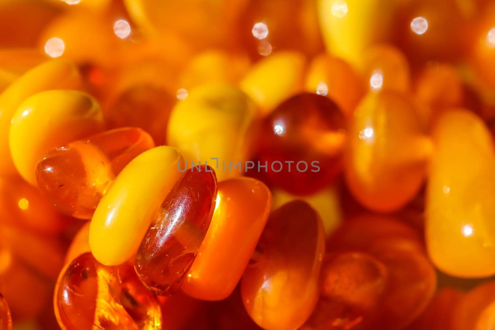 Sunny beads of fire amber. Natural gemstone background, jewelry concept