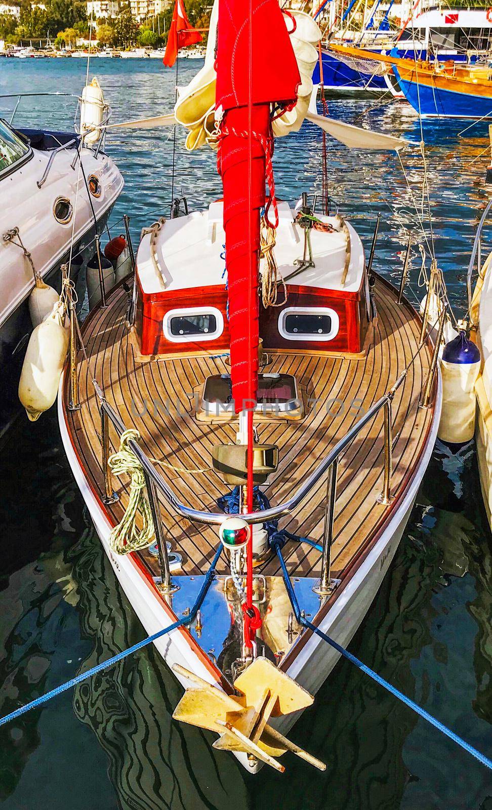 Small red sail yacht in marina. Smile