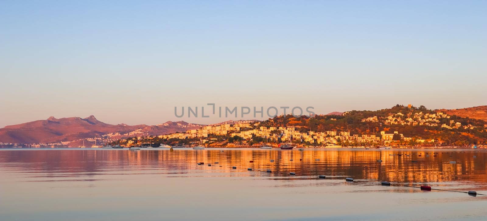 Beautiful bright colorful sunset on the Mediterranean Sea with islands, mountains and boats by Olayola