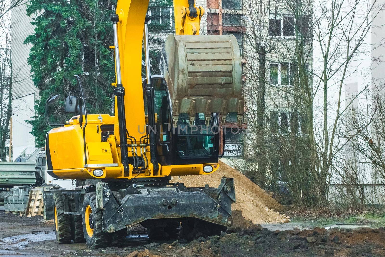 Excavation work in the city. Construction or industrial equipment on the street digs the ground.