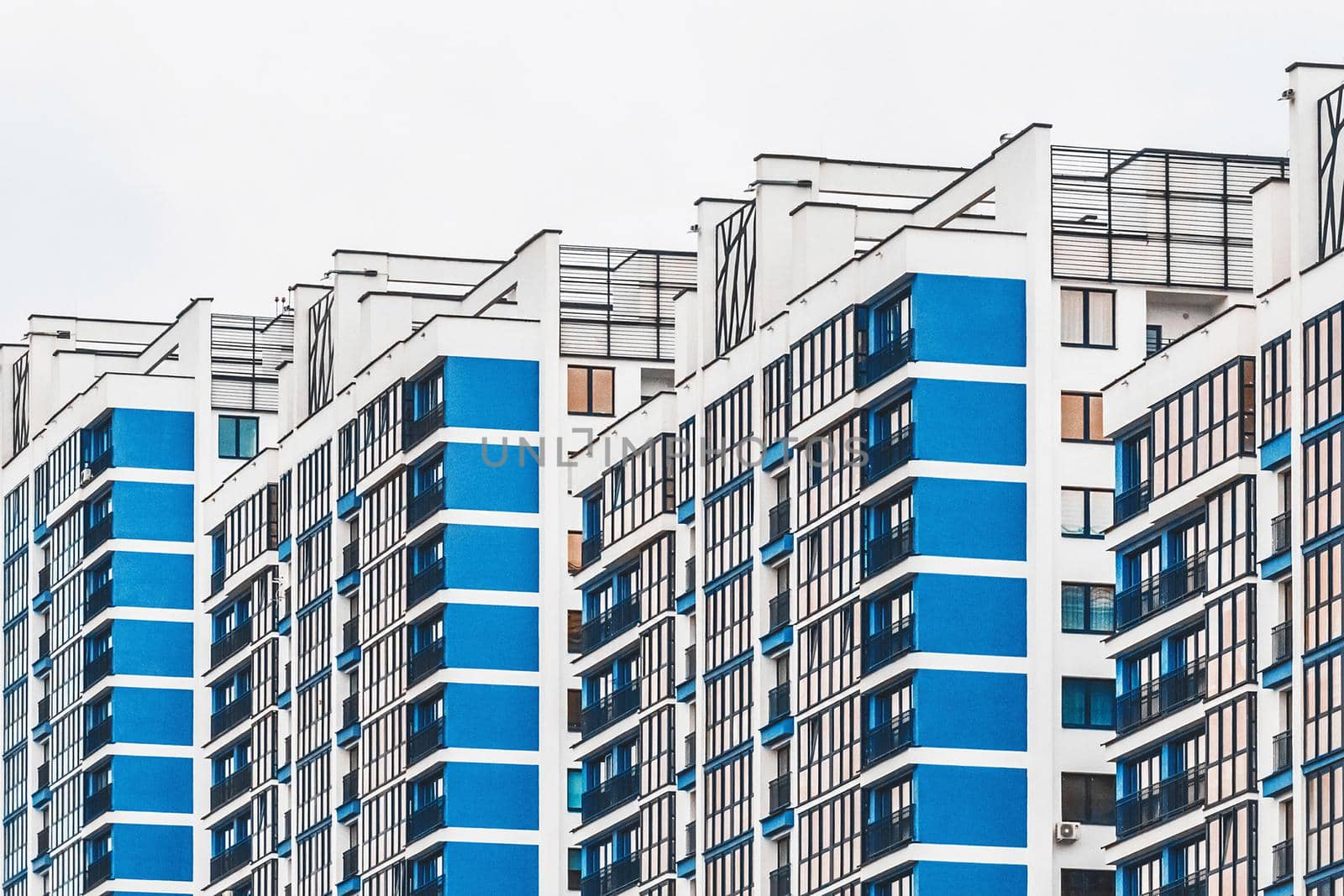 New modern high-rise apartment urban building exterior, facade of a residential city house.