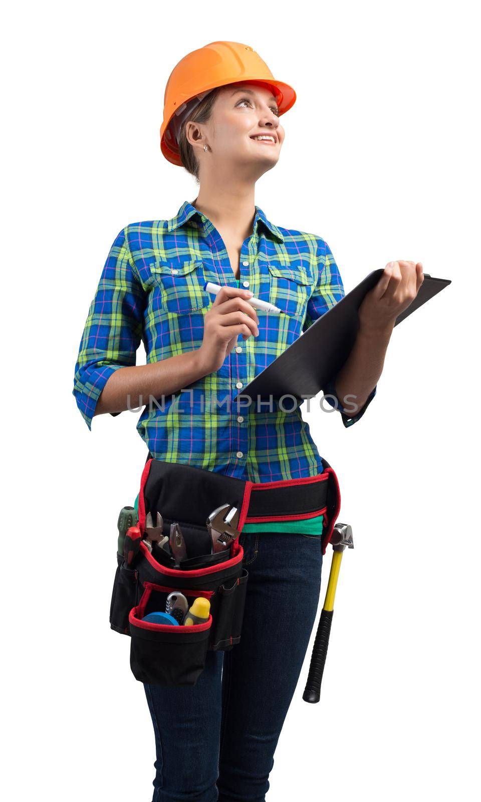 Young building inspector in workwear isolated on white background. Female construction worker in safety helmet standing with clipboard checklist and looking up. Professional architecture audit service