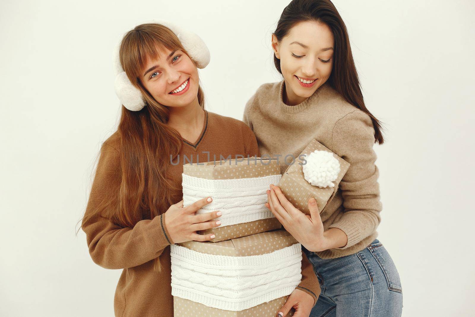 Women with presents. Girls in a brown sweater. Ladies in a studio.