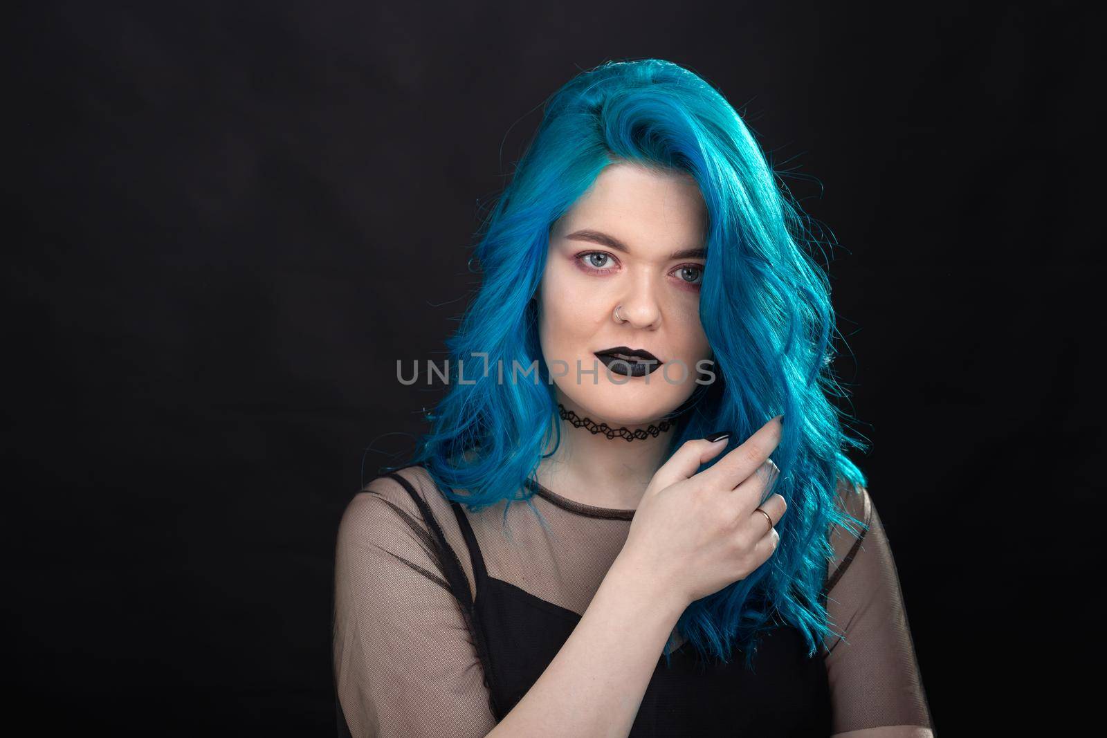 People, style and fashion concept - Close up portrait of young woman with blue long hair dressed in black dress.