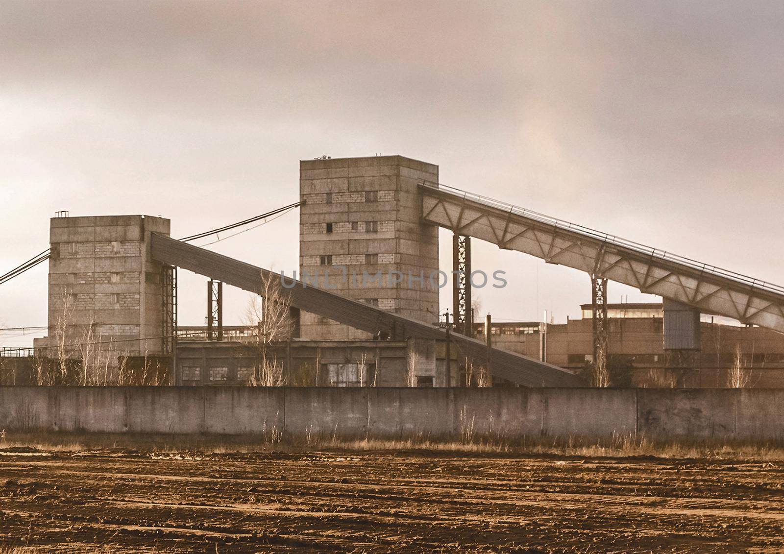 Conveyor belt tower for storing and protecting feed, grain or cement from exposure to water and air. Silo industry, manufacturing, storage tanks on agriculture industrial plant.