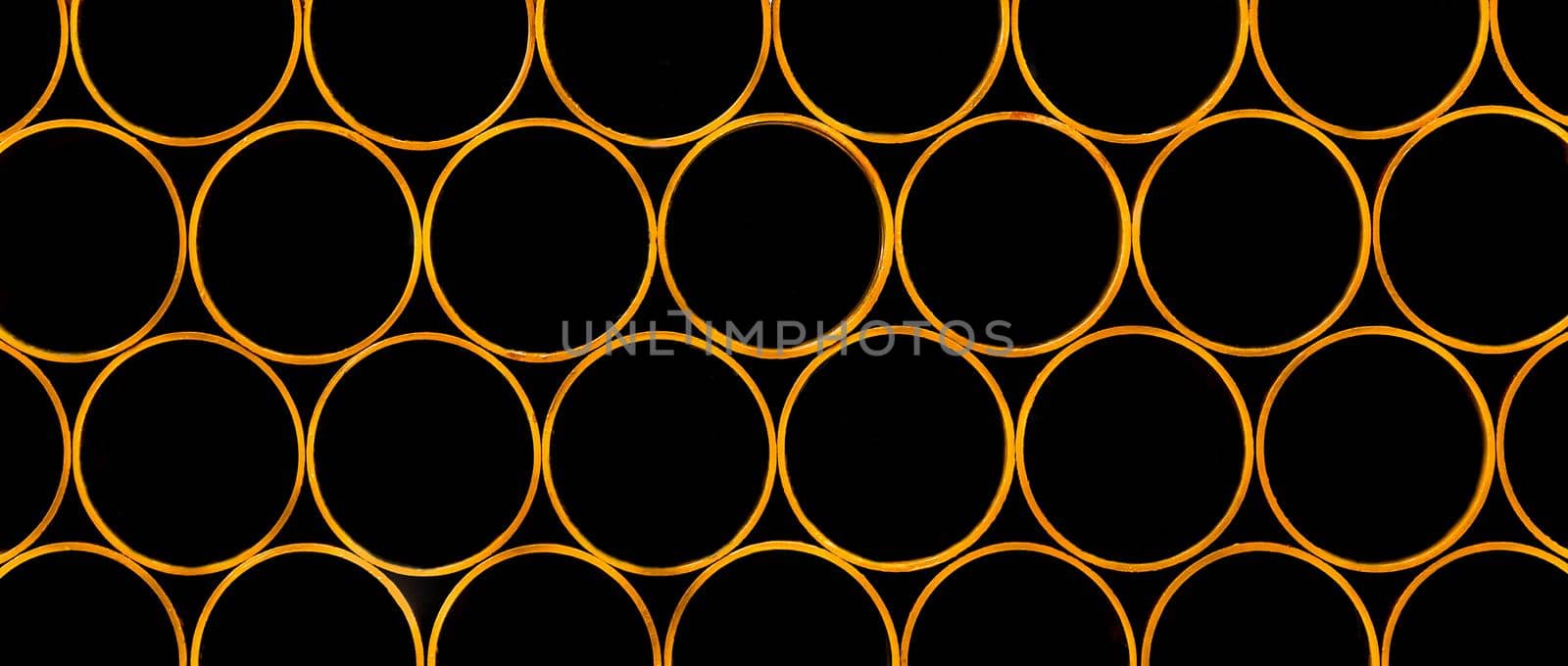 Pile of round industrial material polyethylene thermoplastic pipes on a construction site by AYDO8