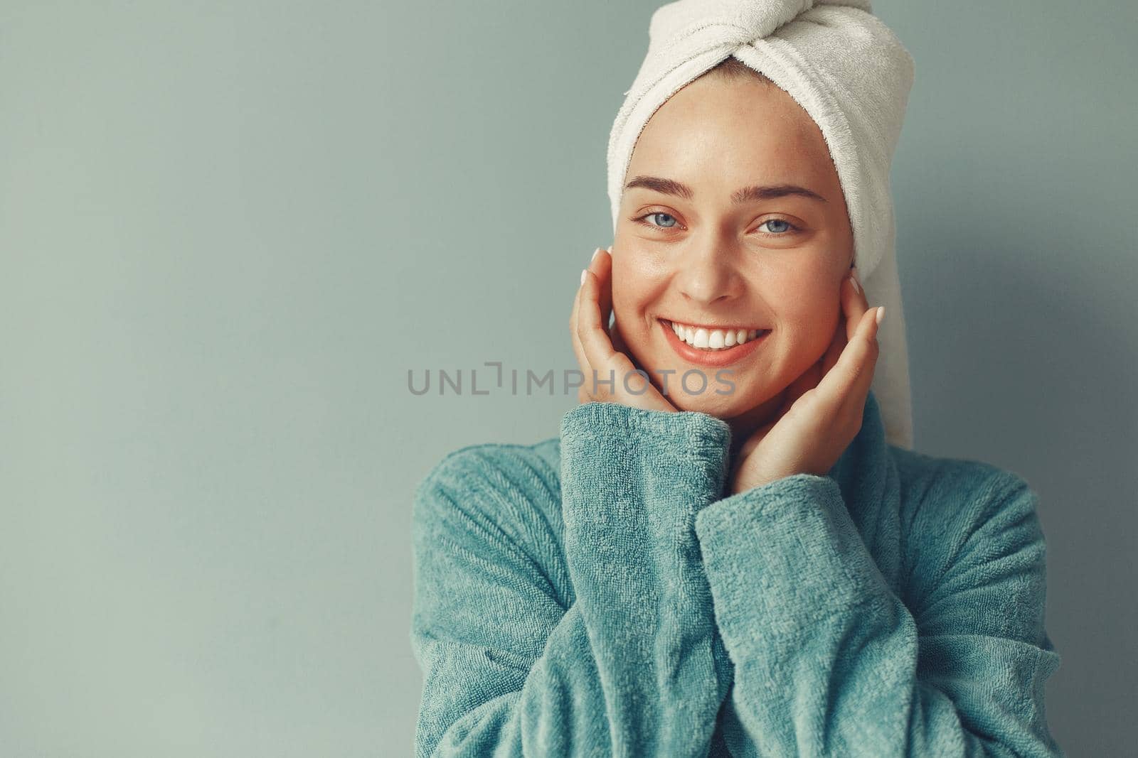 Girl in a studio. Lady in a blue bathrobe.