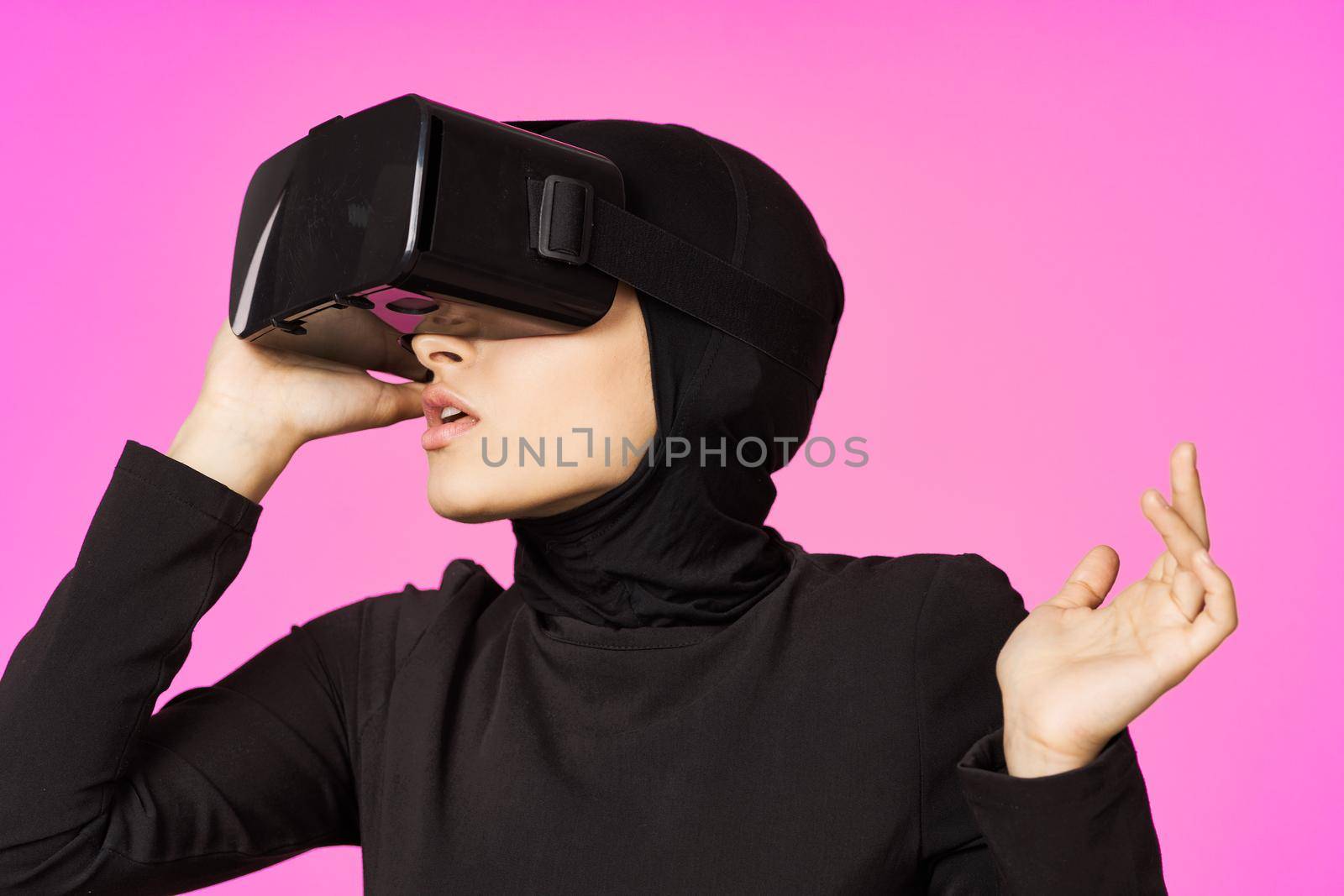muslim woman wearing virtual reality glasses entertainment technology device. High quality photo