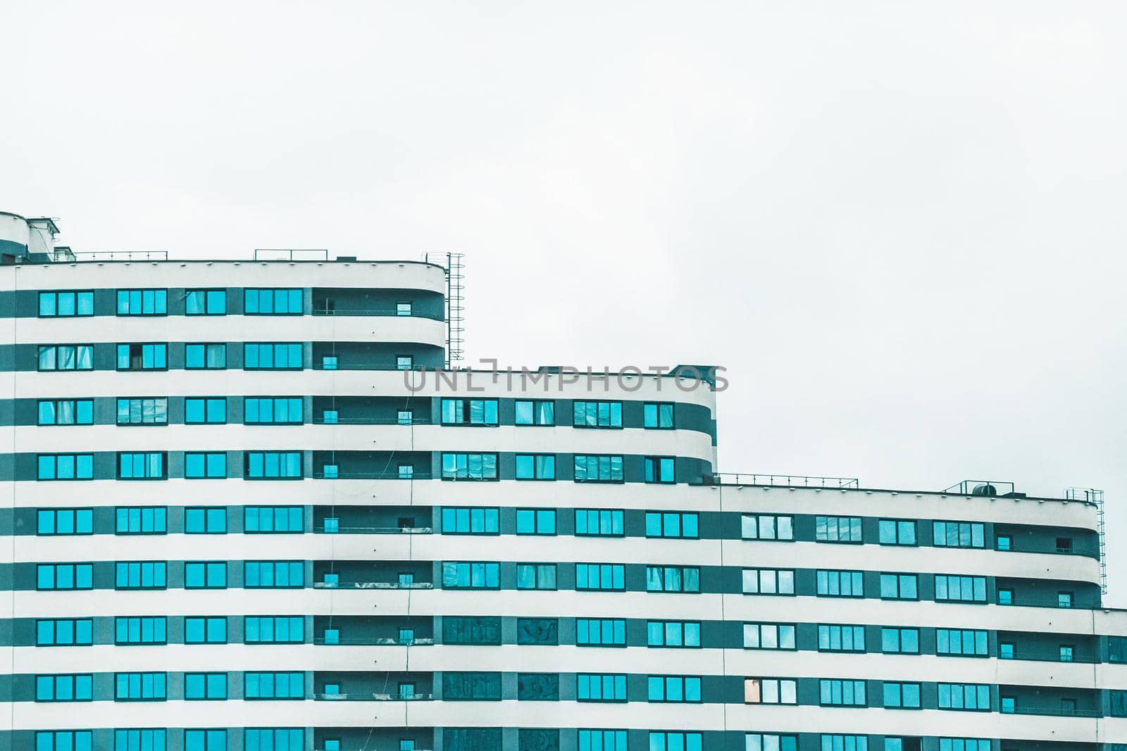 New modern high-rise apartment urban building exterior, facade of a residential city house.