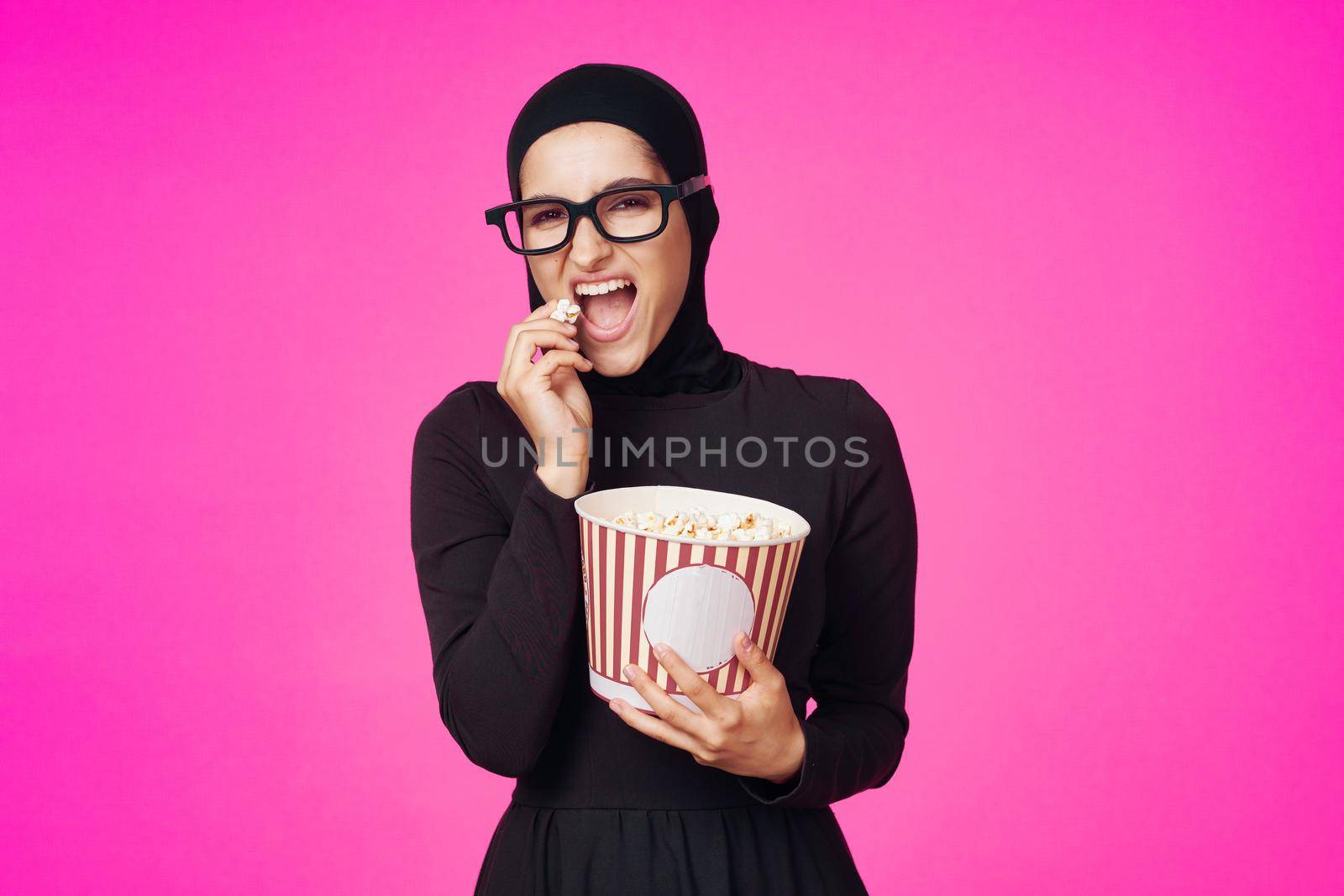 pretty woman attractive look popcorn glasses movie watching studio lifestyle. High quality photo