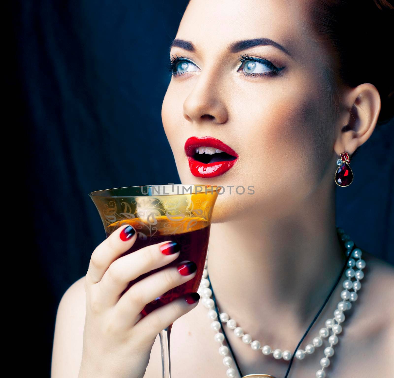 beauty rich woman with bright makeup wearing luxury jewellery on black background, fashion lady close up