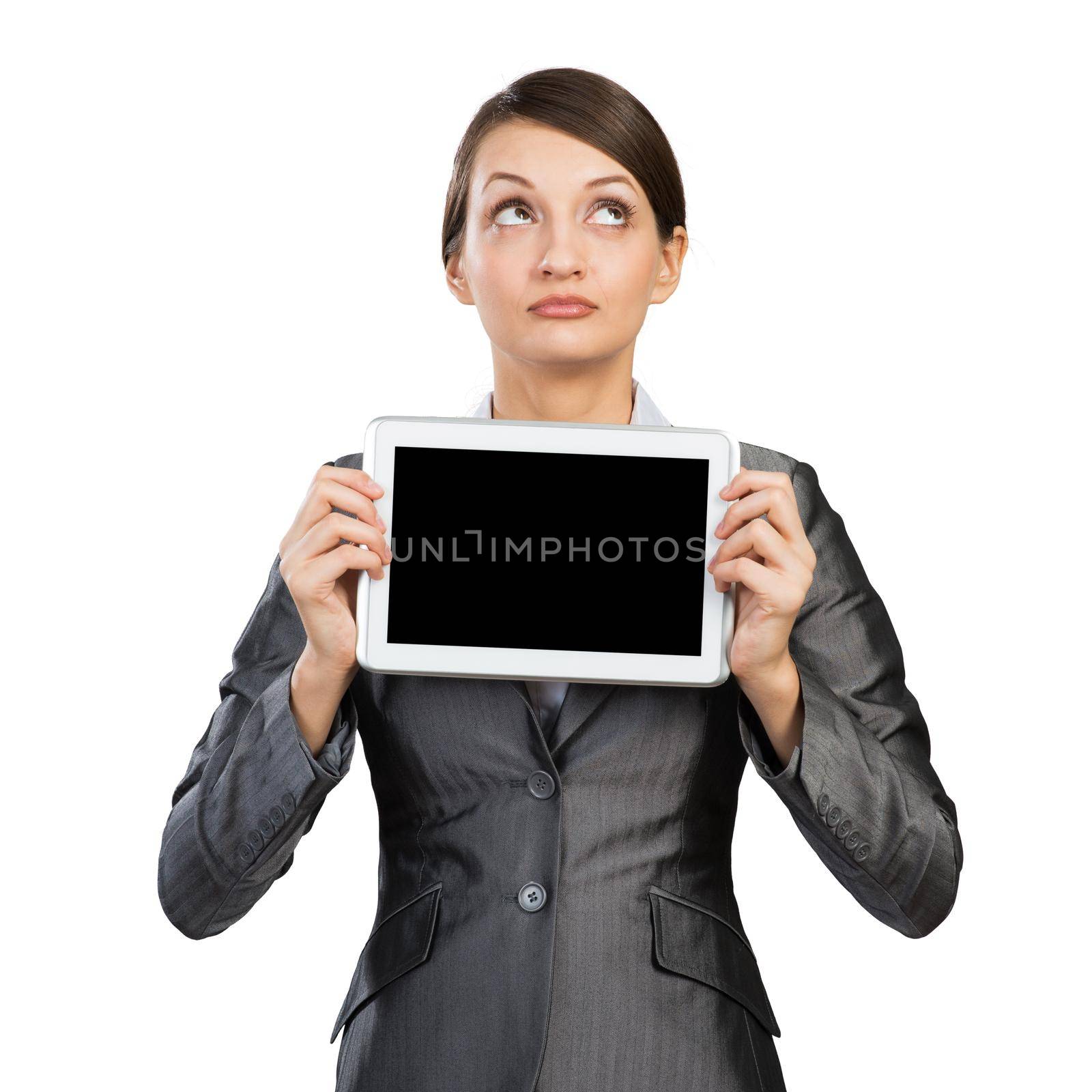 Businesswoman with tablet computer looking upwards. Portrait of attractive woman in formalwear showing tablet PC near her face. Corporate businessperson and digital technology layout with copy space