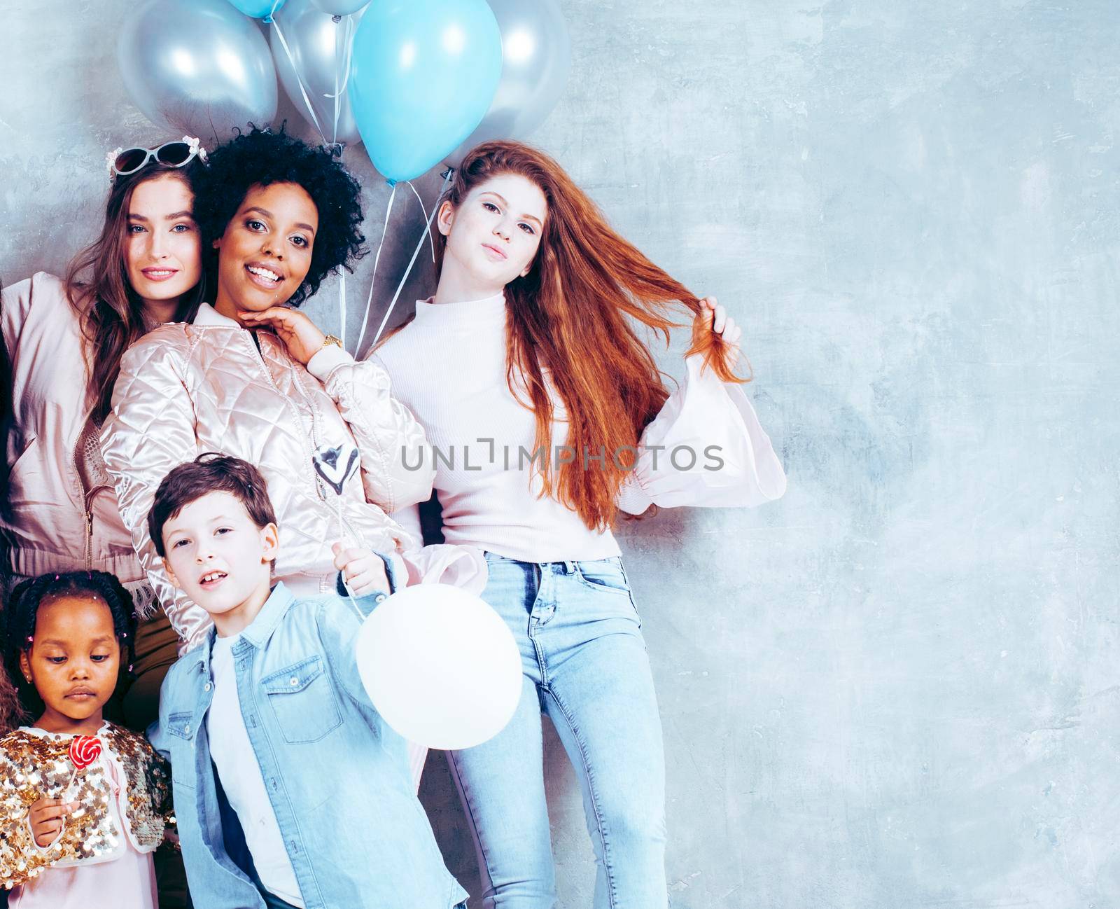 Lifestyle and people concept: young pretty diversity nations woman with different age children celebrating on birth day party together happy smiling, making selfie. African-american, asian and caucasian close up