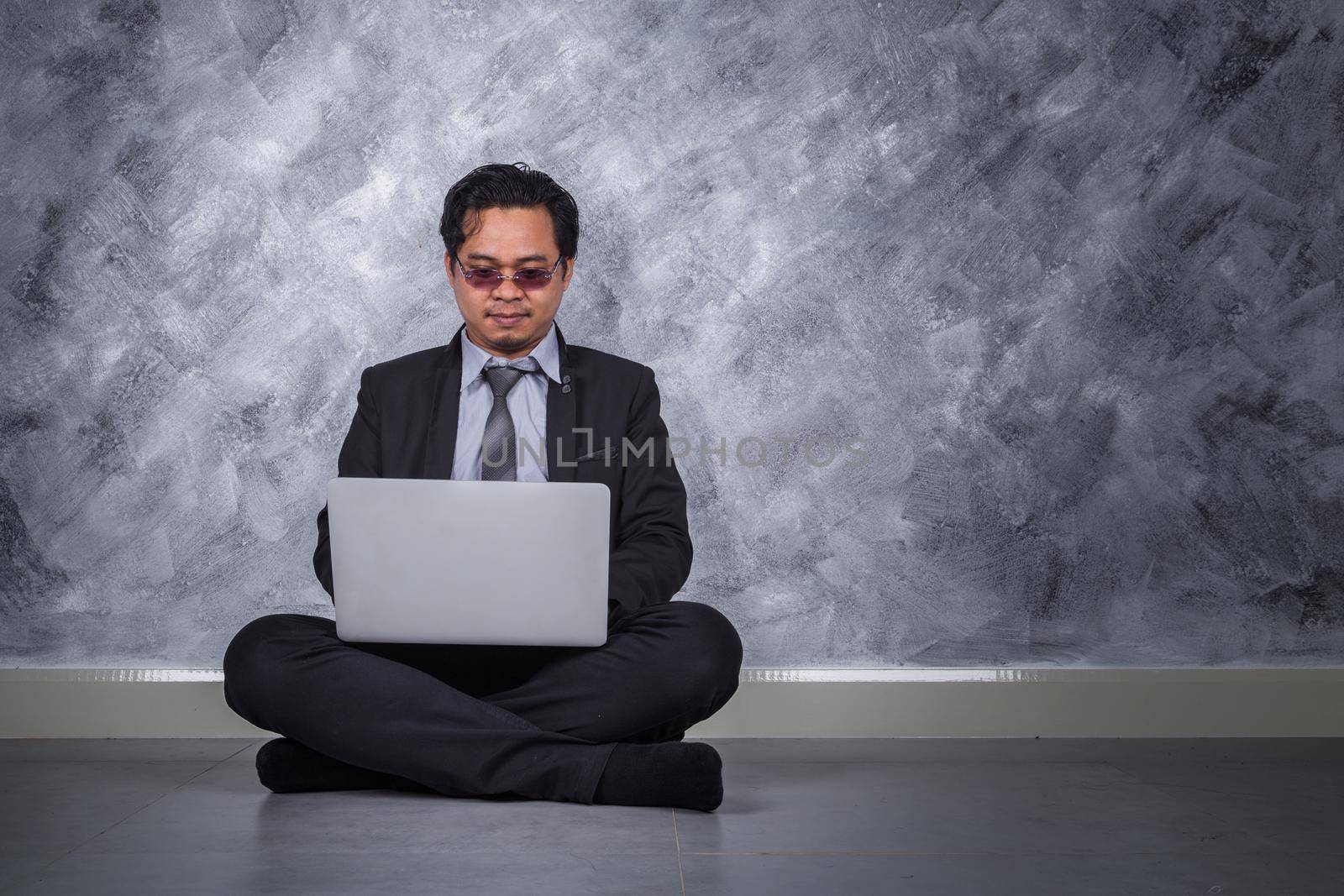 business man sitting and using laptop  by geargodz