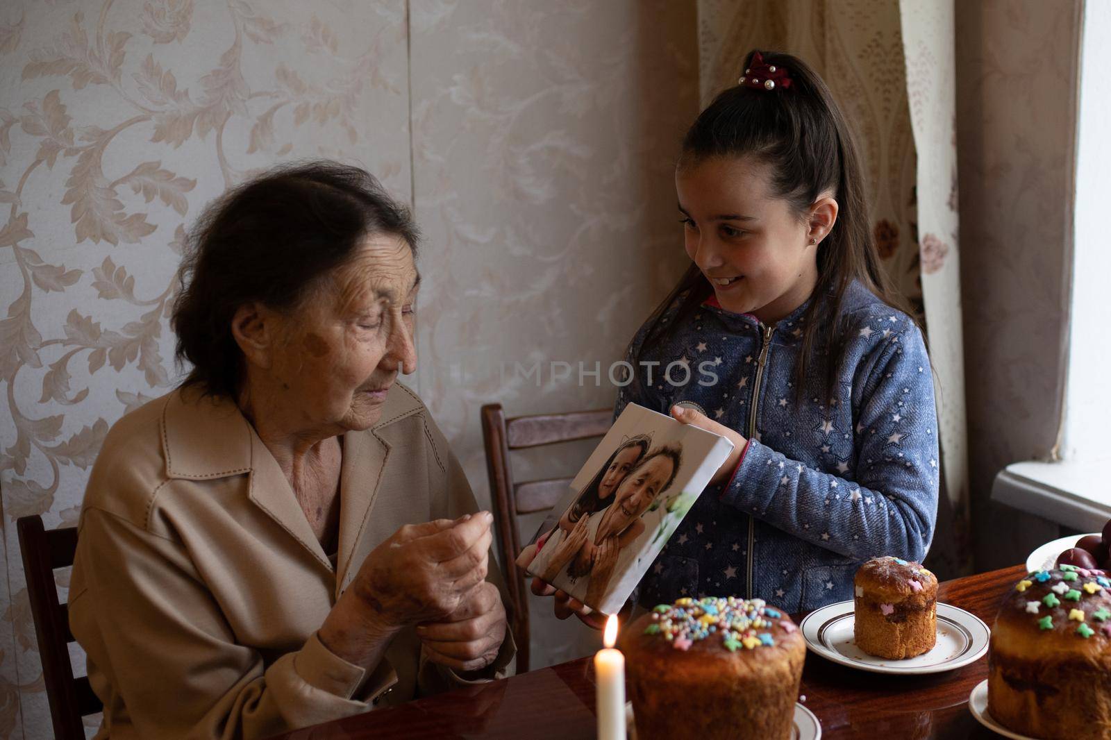 Easter cake in wrinkled hands of senior woman. Happy Easter concept, greeting card
