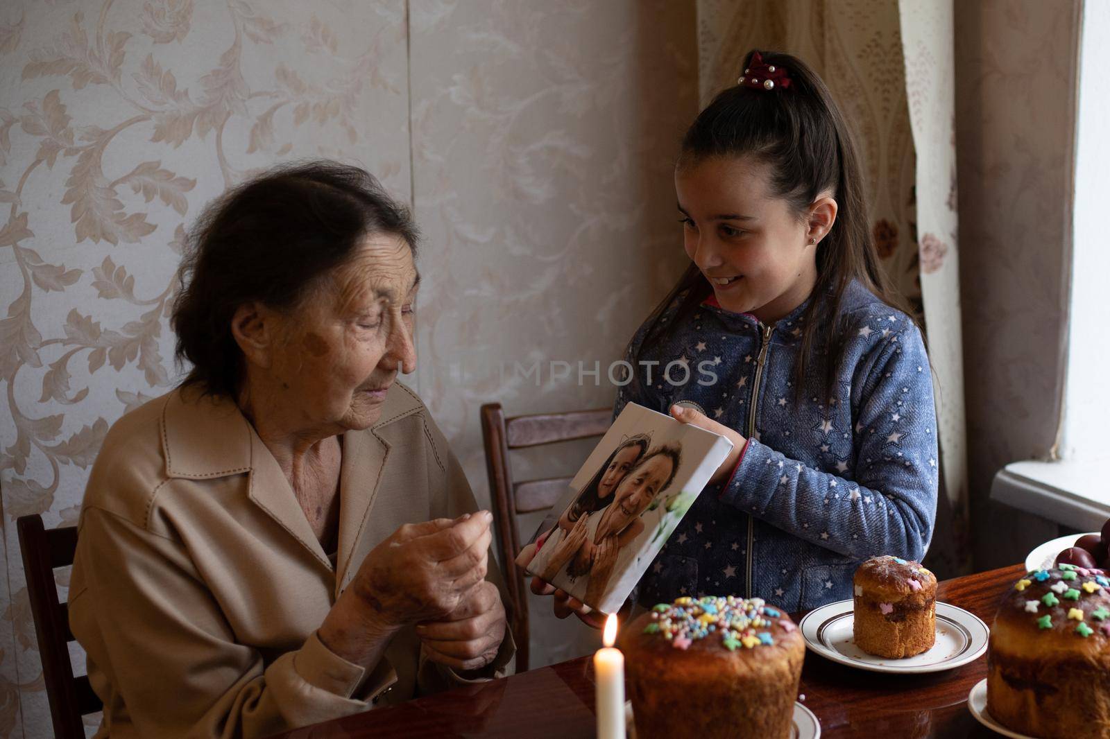 Easter cake in wrinkled hands of senior woman. Happy Easter concept, greeting card. by Andelov13