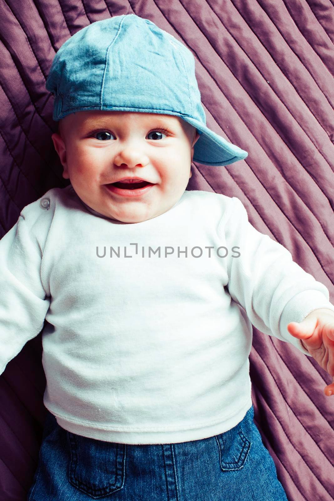 little cute redhead todler in hat happy smiling, lifestyle people concept close up