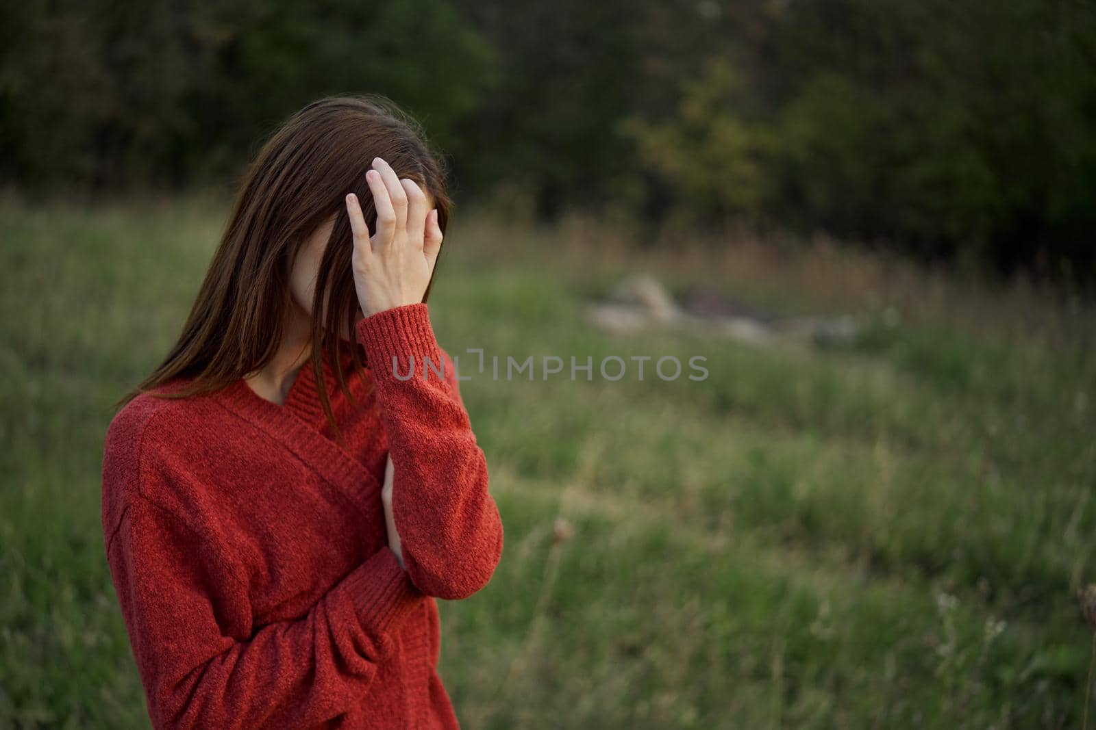 woman in a red sweater outdoors in a field walk by Vichizh