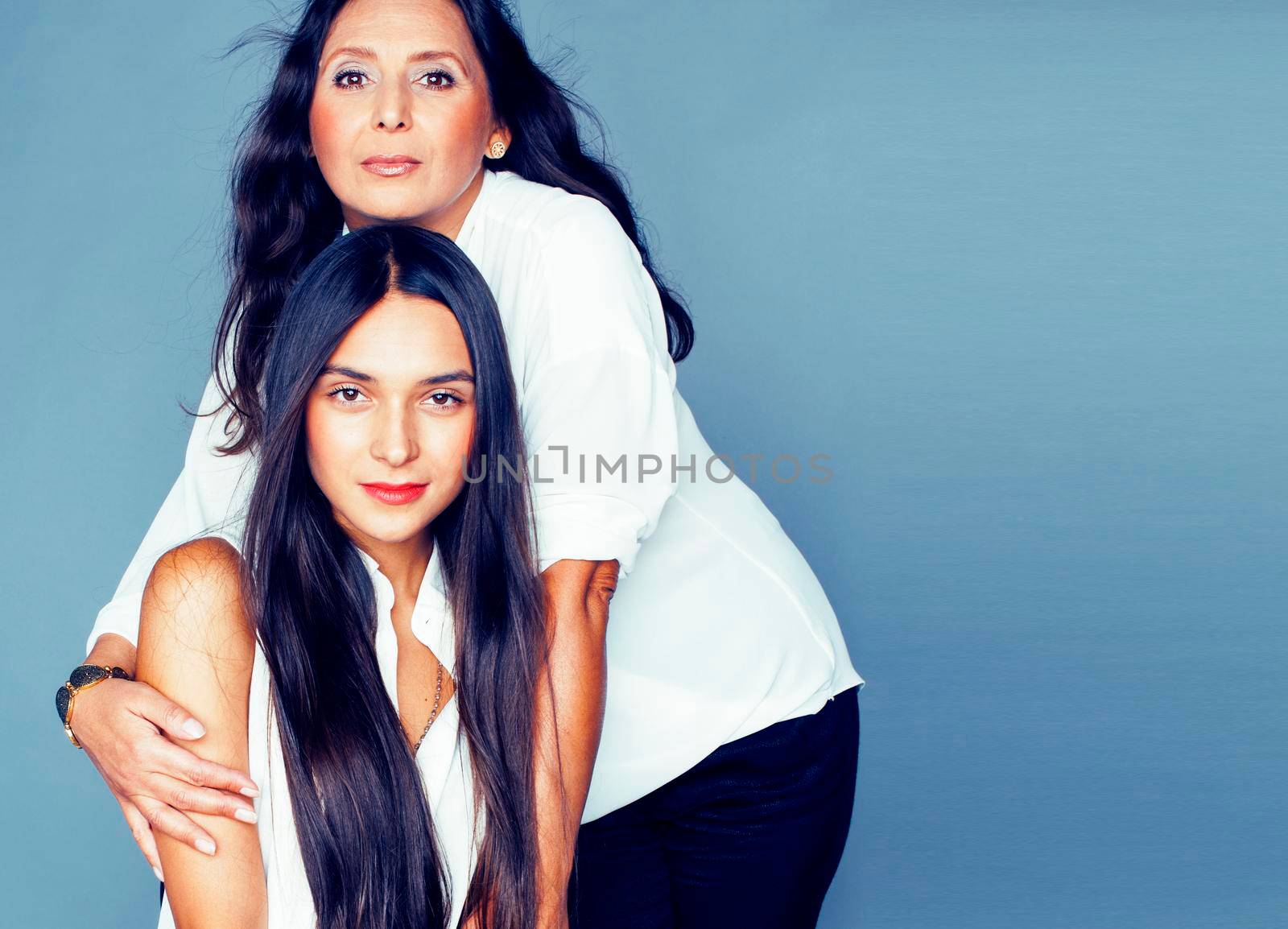 cute pretty teen daughter with mature mother hugging, fashion style brunette, lifestyle people concept close up