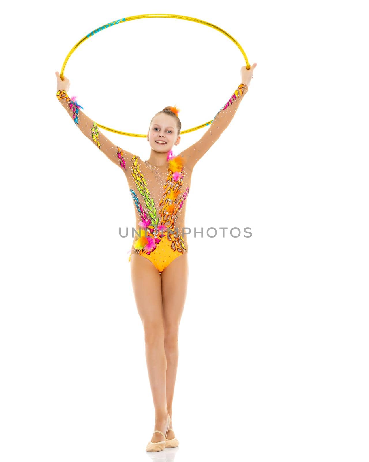 A girl gymnast performs an exercise with a hoop. The concept of gymnastics and fitness. Isolated on white background.